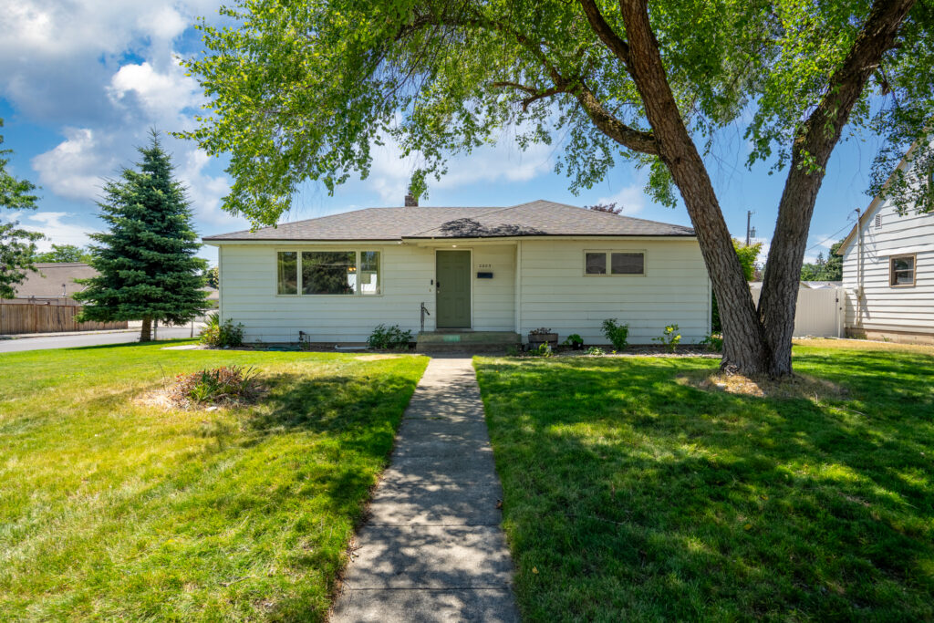 Updated Spokane home with a finished basement, insulated 21×30 shop, RV parking, and landscaped yard. Explore 2803 W Sanson Ave.